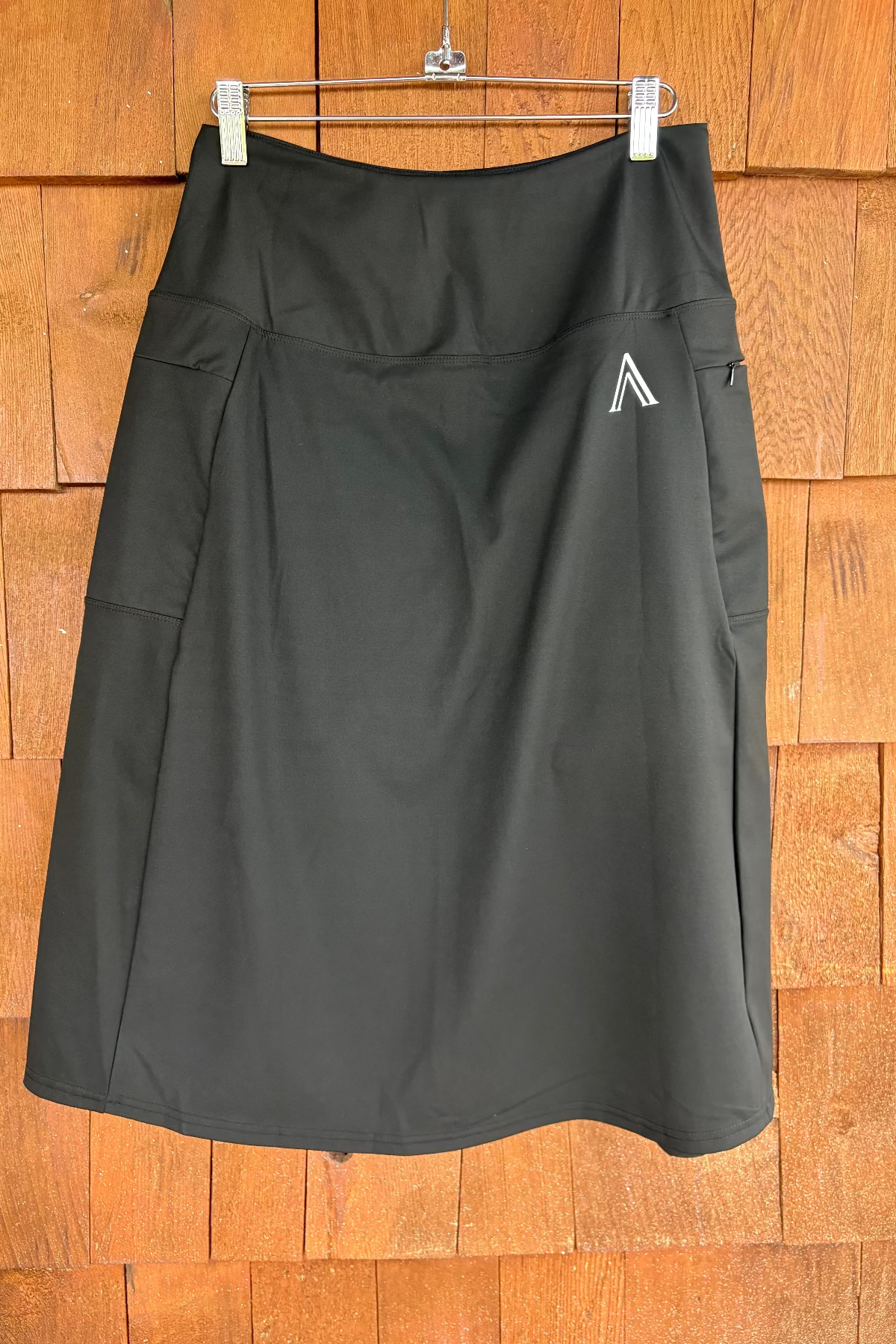Black skirt with a logo on a wooden background