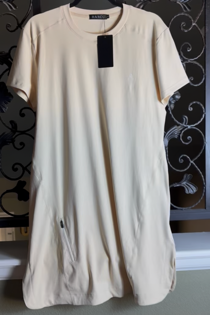 Beige dress on a hanger against a decorative metal gate background